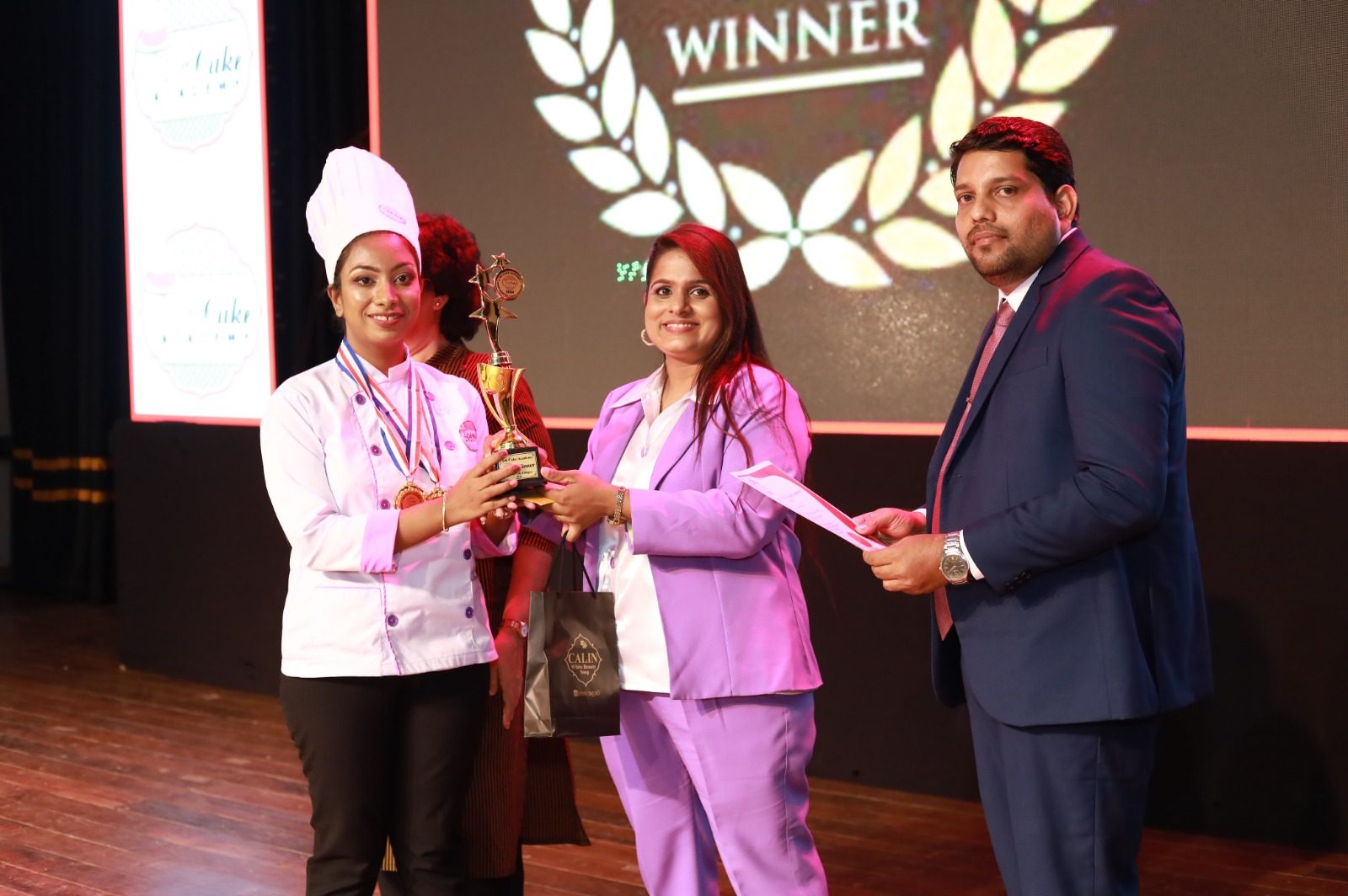 Receiving the Winner trophy at the award ceremony
