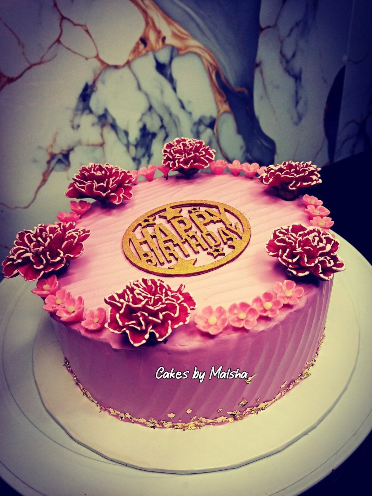 Pink birthday cake with buttercream flowers