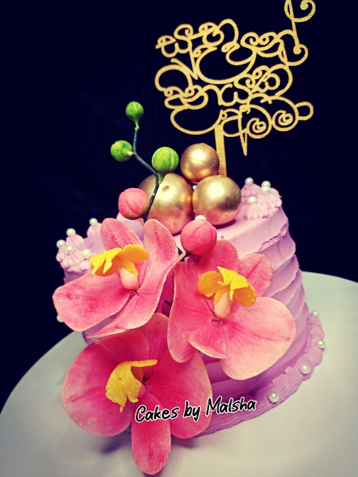Birthday cake with hand-made pink sugar orchids