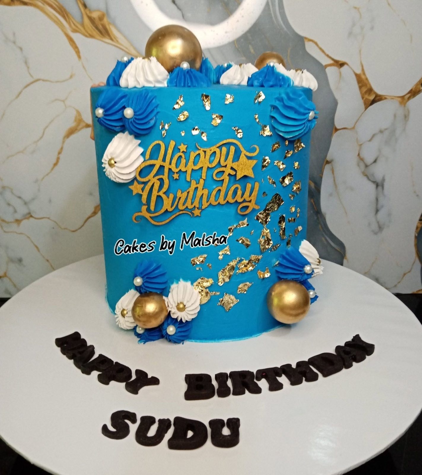 Blue and gold birthday cake