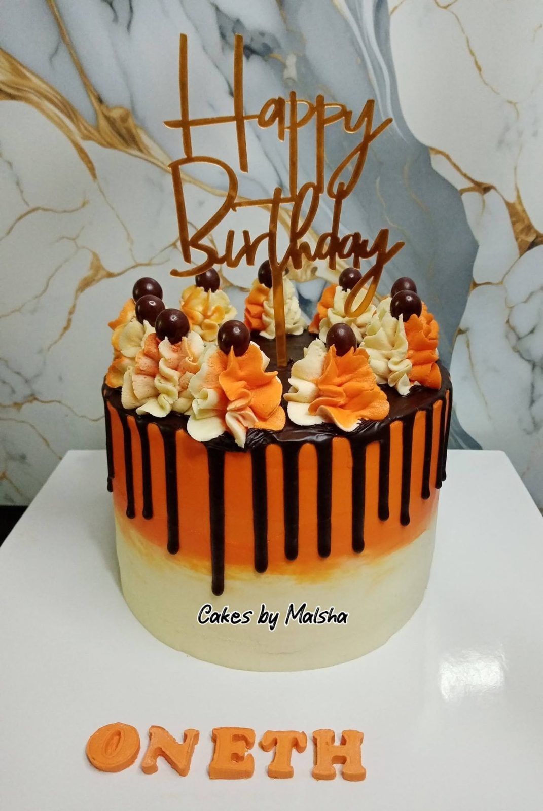 Orange drip birthday cake with chocolates