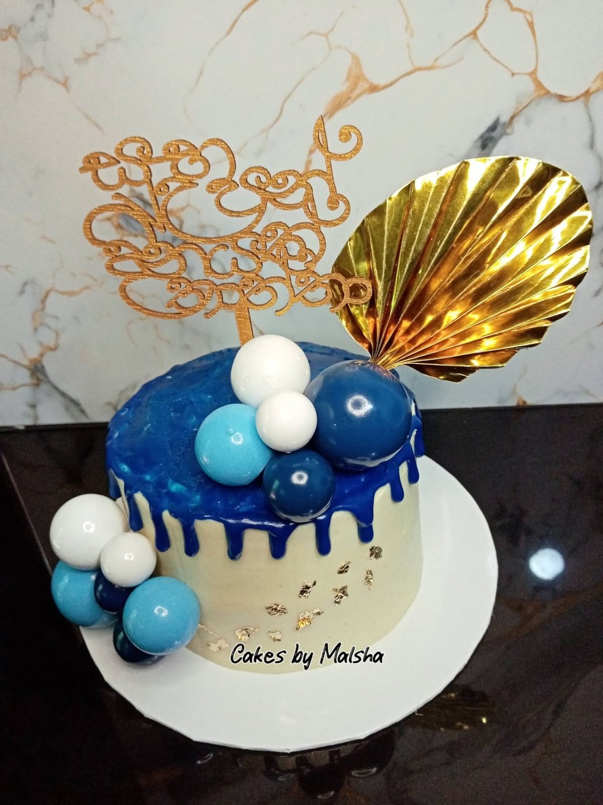 Blue drip cake with gold decorations