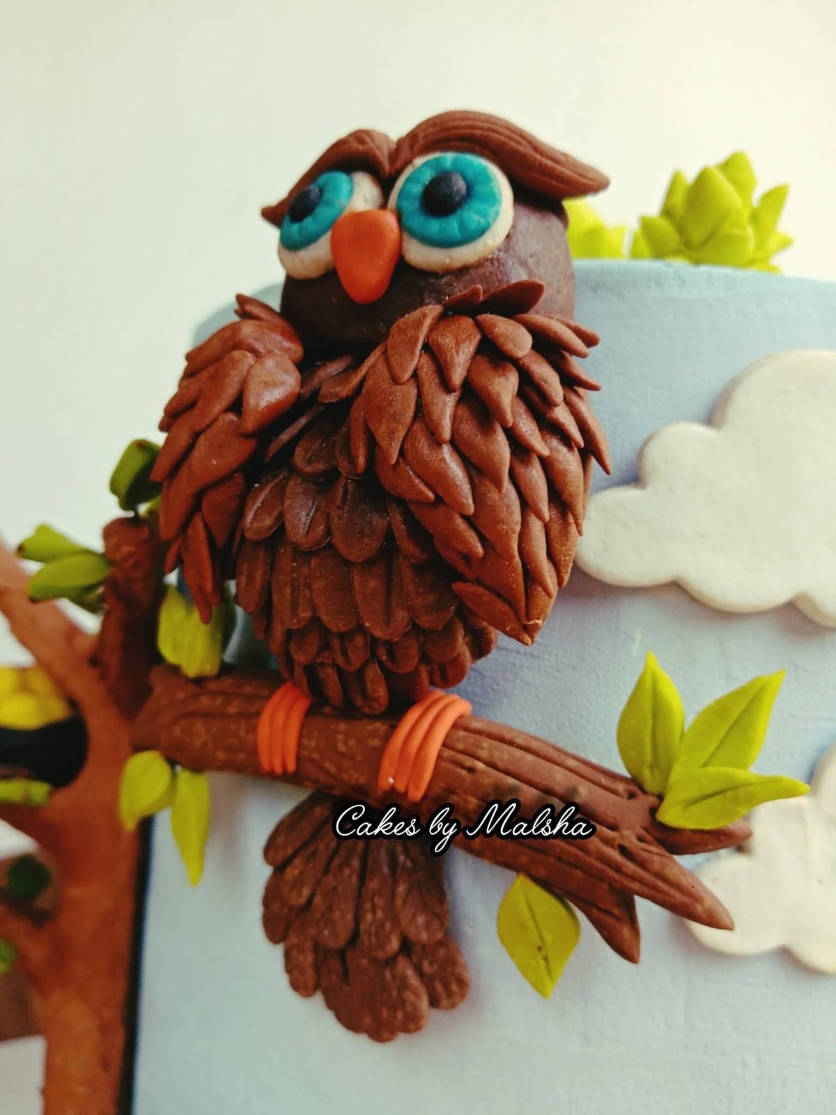 Hand-made sugar owl on a branch